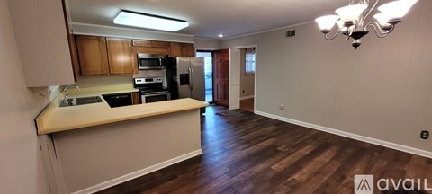 A kitchen with wooden cabinets and a countertop.