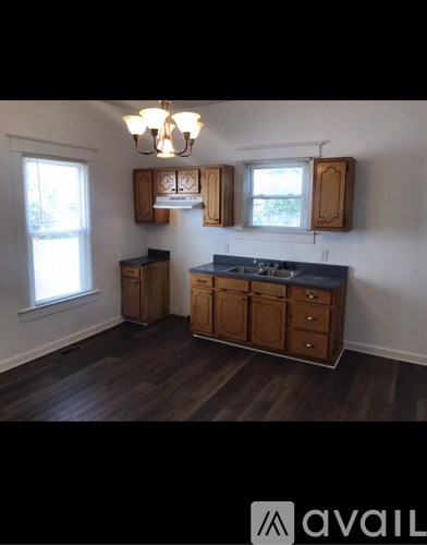 A kitchen with wooden cabinets and a blue countertop.