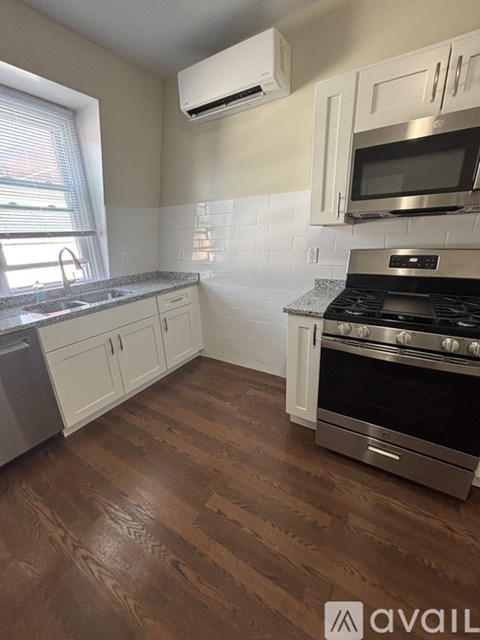 A kitchen with a stove top oven and microwave above it.
