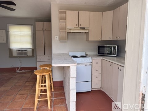 A kitchen with a white dishwasher and a microwave.