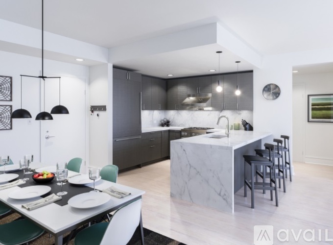 A modern kitchen with a dining table set for four.