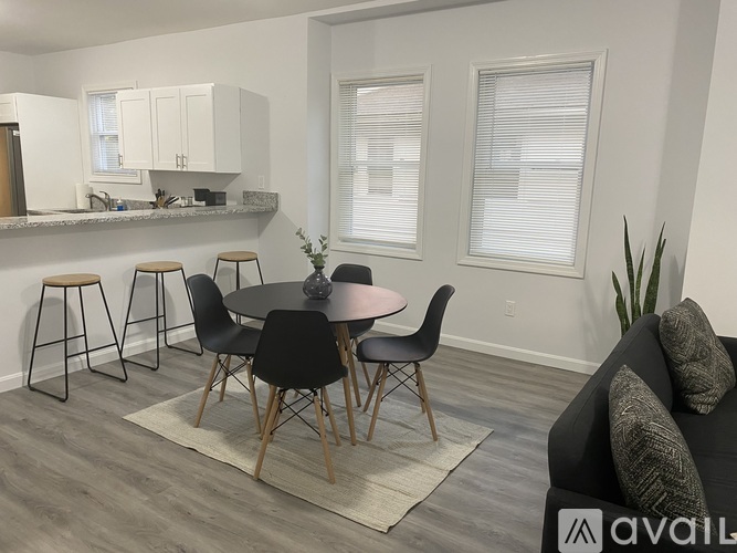 A modern dining room with a round table and chairs.