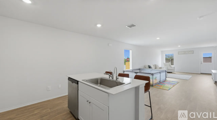A modern kitchen with white cabinets and a large island.