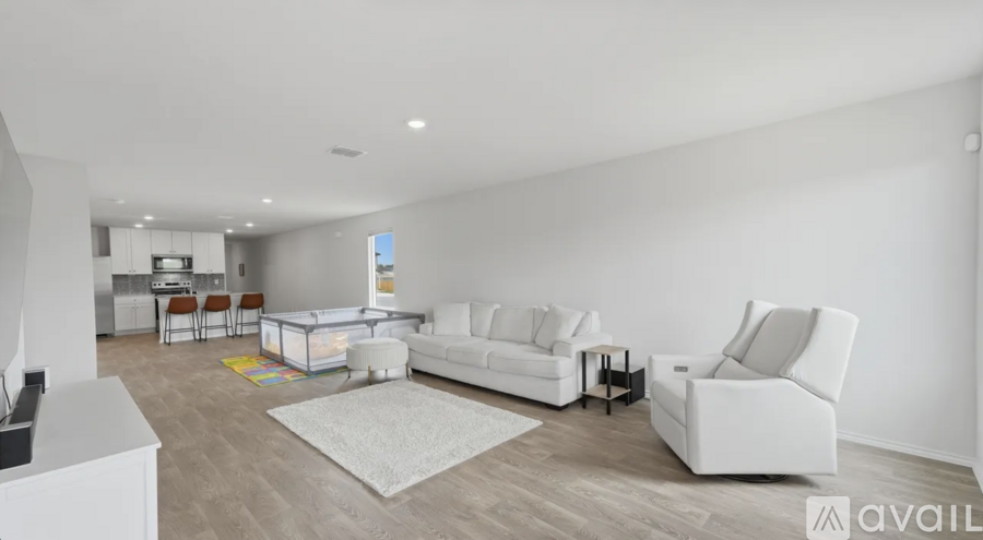 A living room with white furniture and a white couch.