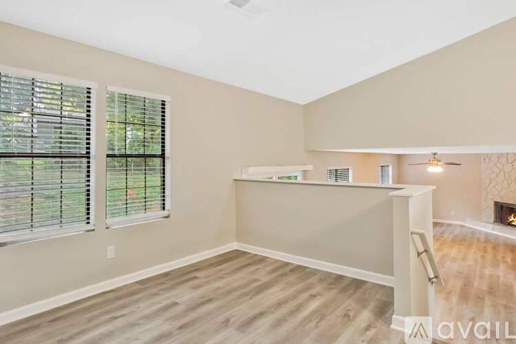 A room with a fireplace and a window with blinds.