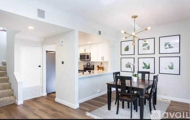 A dining room with a table set for four.