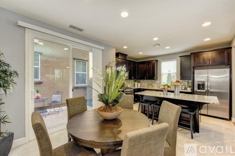 A modern dining room with a wooden table and chairs.