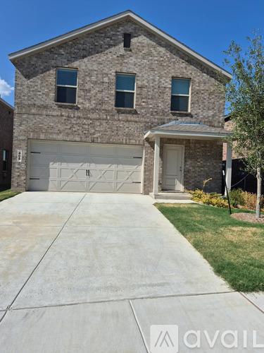 A house with a garage and a driveway in front.