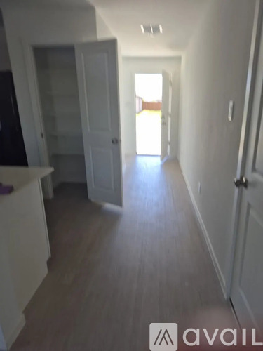 A long hallway with a door at the end.