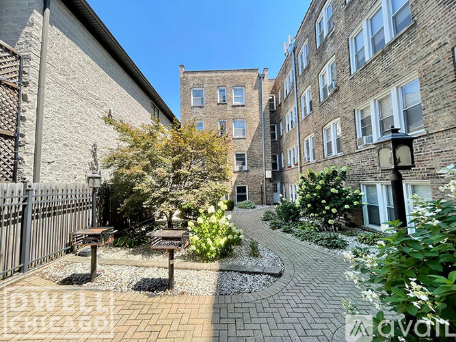 A brick building with a tree in front of it.