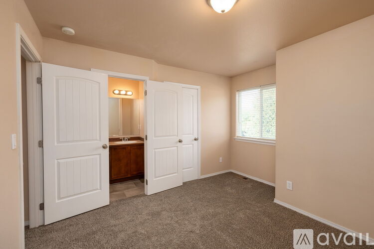 A bedroom with a bed, dresser, and closet.