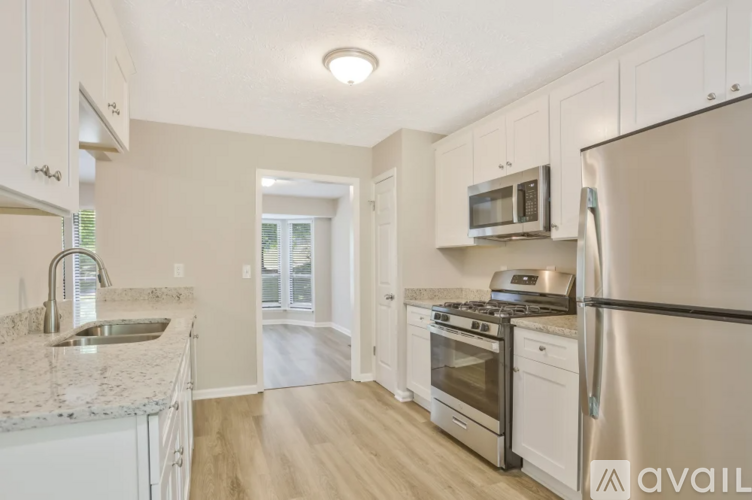 A kitchen with a granite countertop and stainless steel appliances.