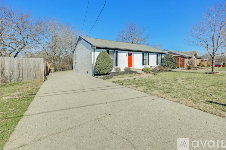 A house with a red door is available for sale.