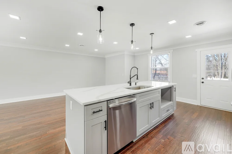 A kitchen with a white countertop and stainless steel appliances.