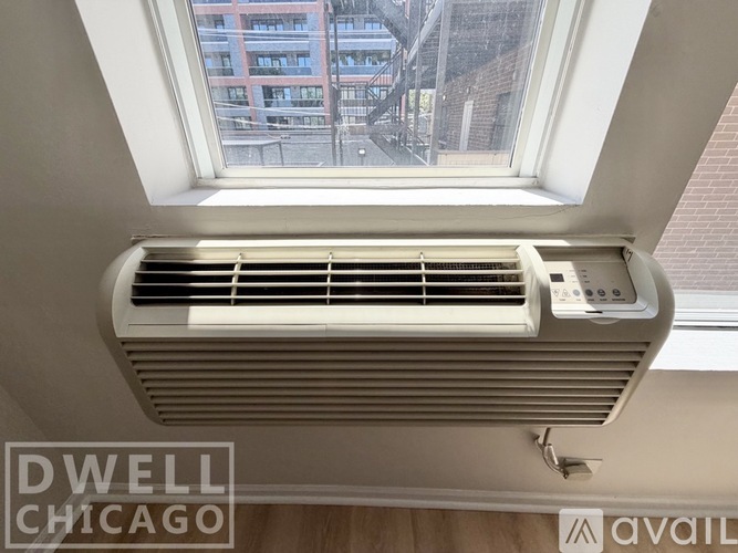 A Dwell Chicago air conditioning unit is installed in a window.