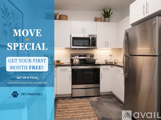 A kitchen with a refrigerator, microwave, and oven, with text advertising a free first month for a tour.