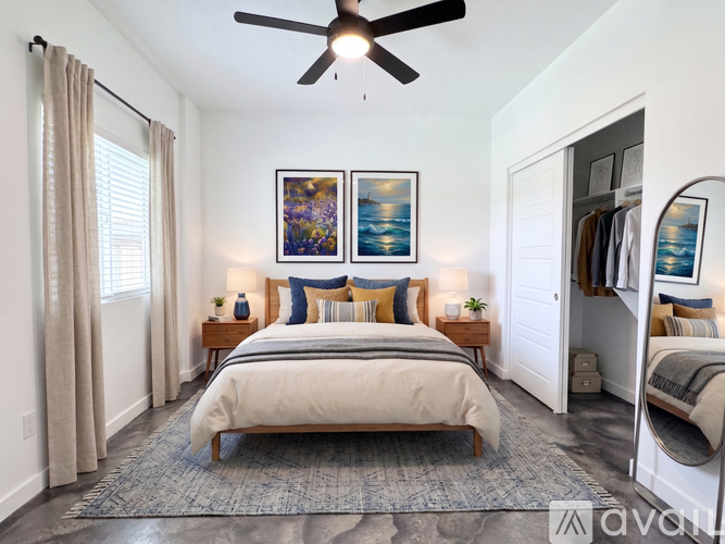 A bedroom with a large bed and a ceiling fan.