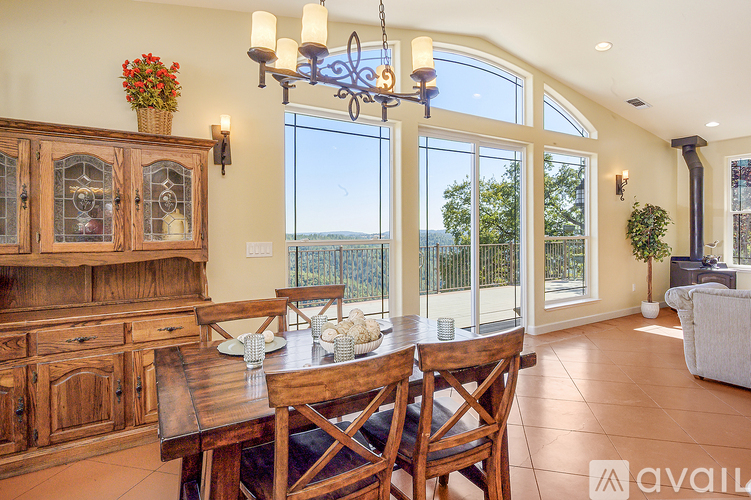 A dining room with a wooden table and chairs.