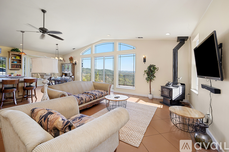 A living room with a couch, a television, and a fireplace.