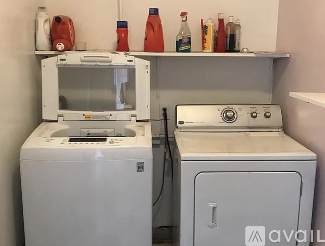 A white washing machine and dryer in a small laundry room.