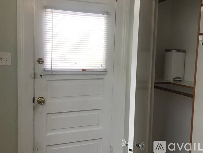 A white door with a window above it.