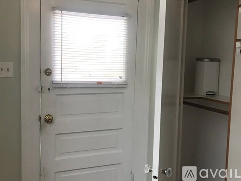 A white door with a window above it.