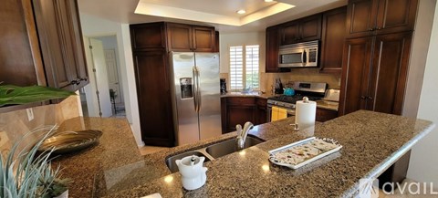 A kitchen with granite countertops and stainless steel appliances.