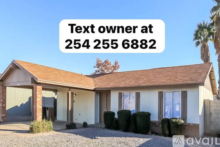 A house with a sign offering to text the owner at a given number.