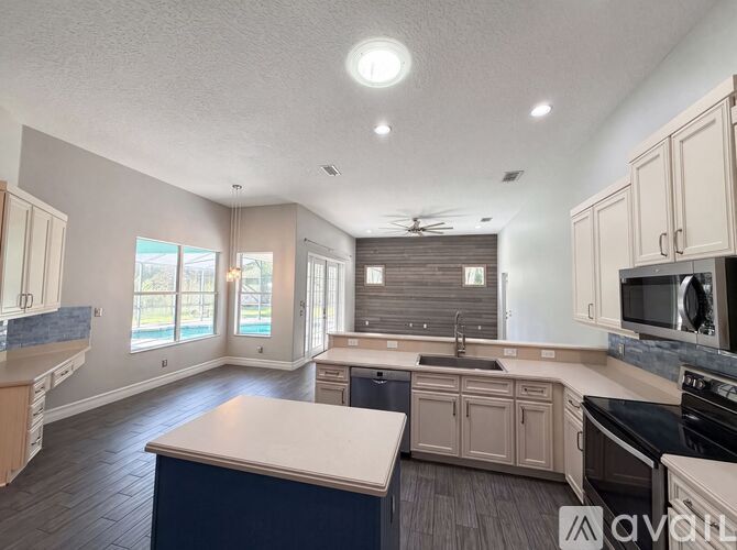 A spacious kitchen with a large island in the center.