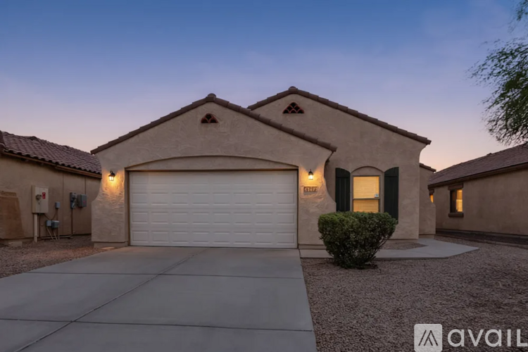 A house with a garage and a driveway is available for sale.