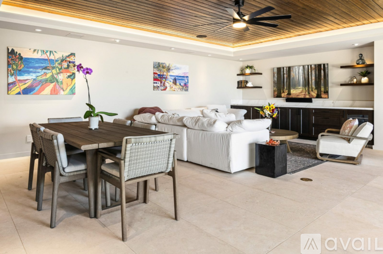 A modern dining room with a wooden table and chairs.