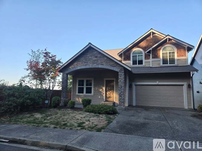 A house with a garage and a driveway is available for sale.