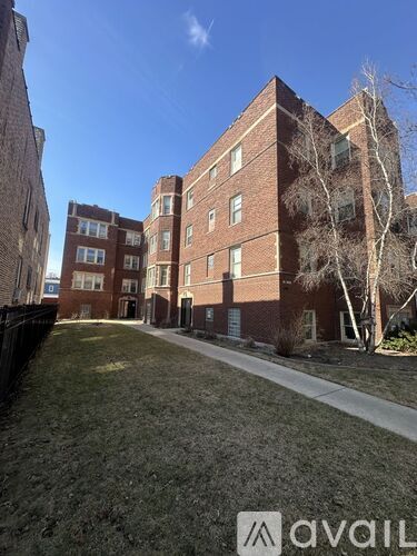 A brick building with a tree in front of it.