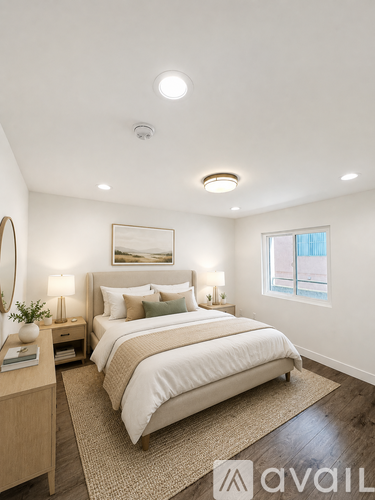 A bedroom with a large bed and a window.