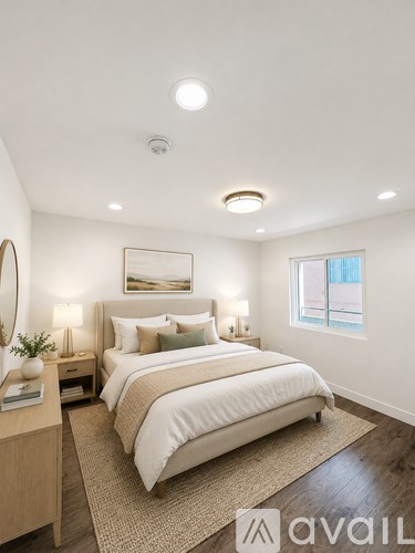 A bedroom with a large bed and a window.