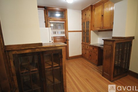 A kitchen with wooden cabinets and a wine rack.