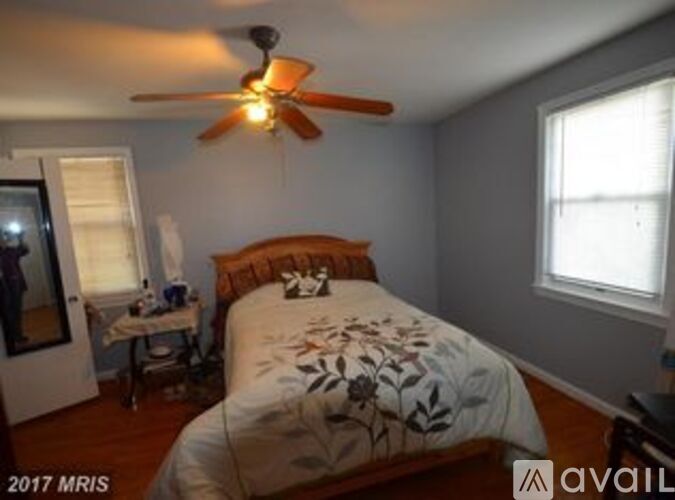 Bedroom with a bed, a ceiling fan, and a window.