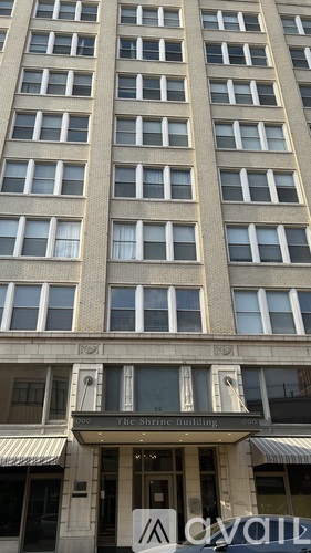A tall building with a sign that says "The Shine Building".