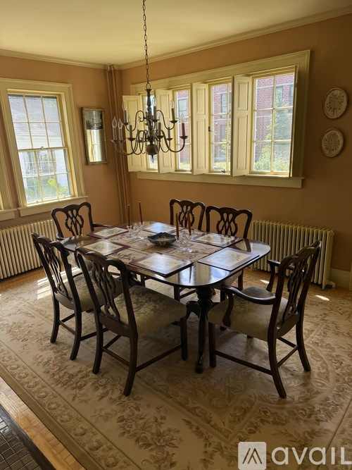 A dining room with a table set for six.
