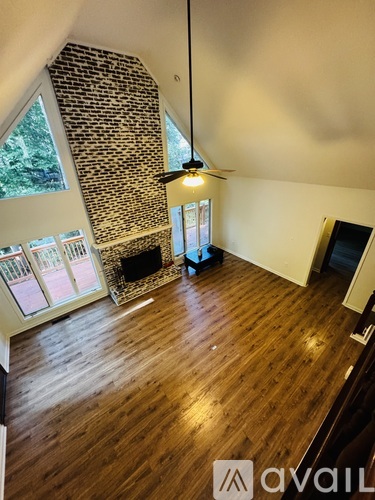A room with wooden floors and a ceiling fan.