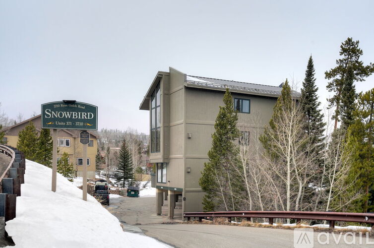 A sign that says Snowbird in front of a building.