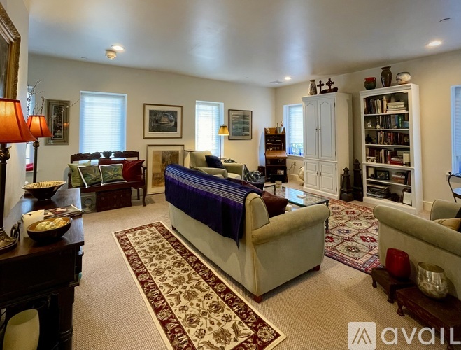 A well-furnished living room with a large bed in the center.