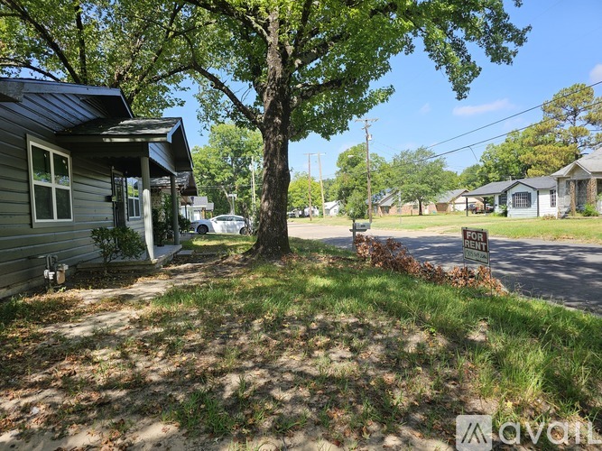 A house with a "For Rent" sign in front of it.