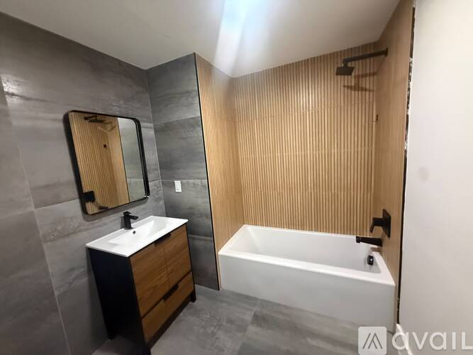 A bathroom with a white sink and a white bathtub.