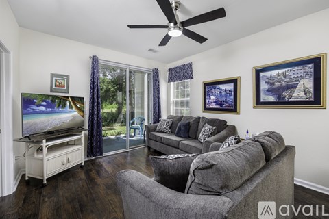 A living room with a grey couch and a television.