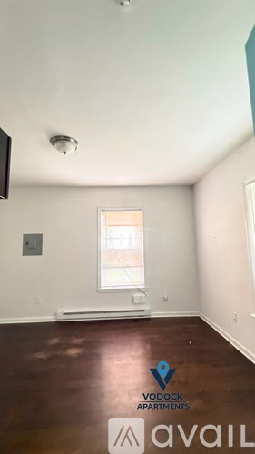 A room with a window and a sign on the floor.