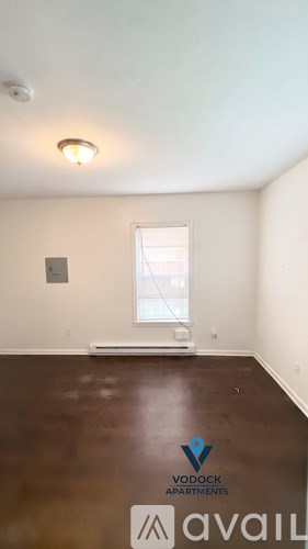 A room with a Vodock Apartments logo on the floor.