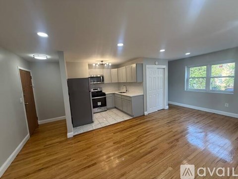 A kitchen with wooden floors and white walls.