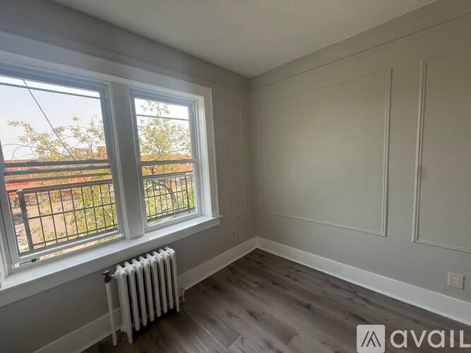 A room with a window and a radiator on the floor.