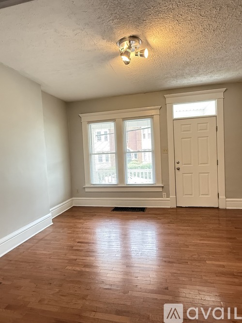 A room with wooden floors and a white door.